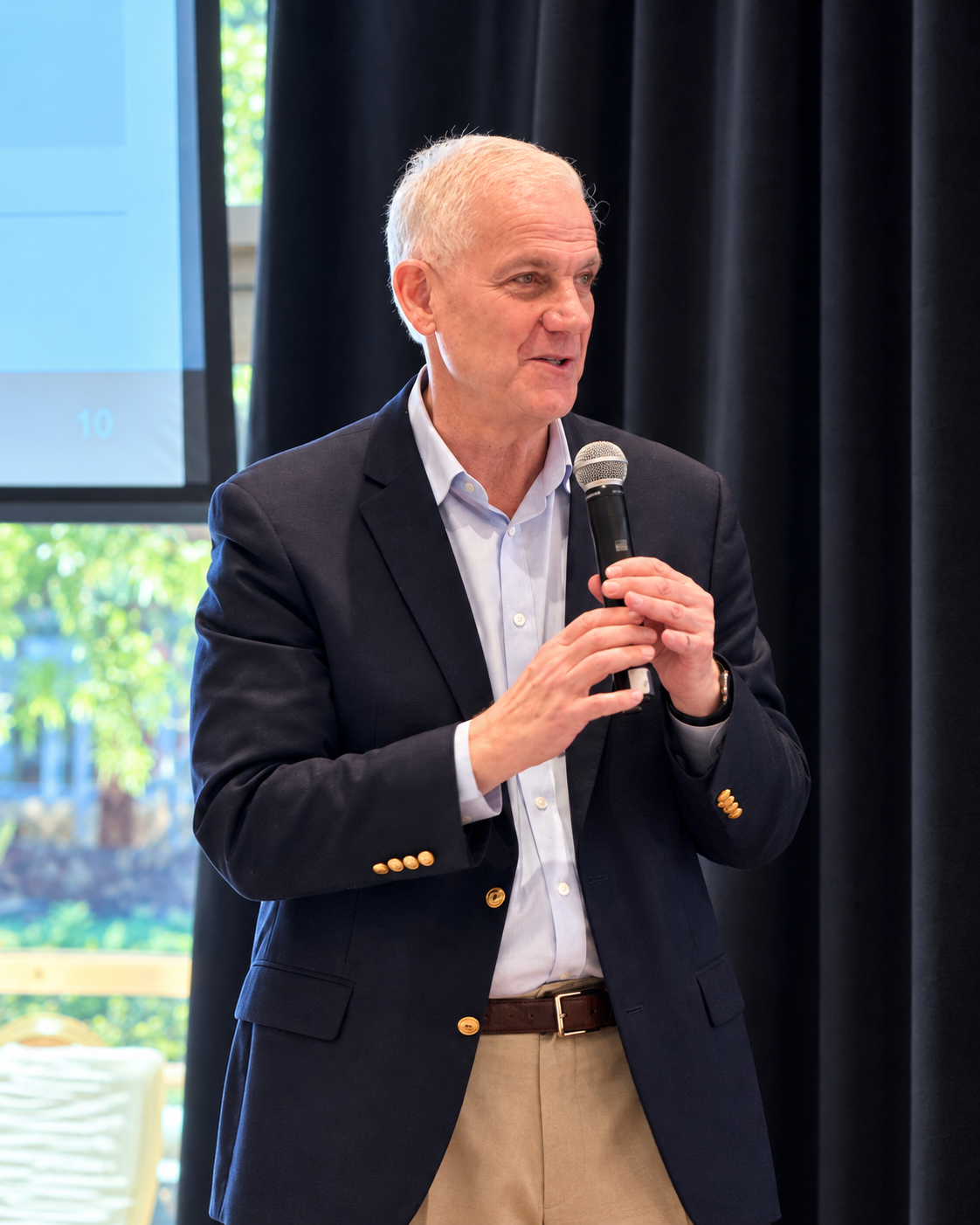 Dan Varroney speaking with a microphone at Energy Marketers of America.